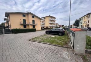 a car parked in a parking lot next to a building at Casa Similli in Lucca
