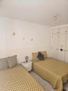 a bedroom with two beds with polka dot sheets at Pedrogão Soul & Sunset in Pedrógão