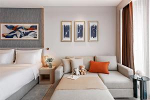 a living room with a bed and a couch at The Meydan Hotel Dubai in Dubai