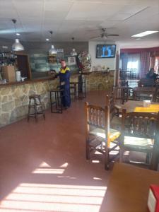 a man standing at a bar in a restaurant at Hostal Marcela Berge in Berge +13 photos