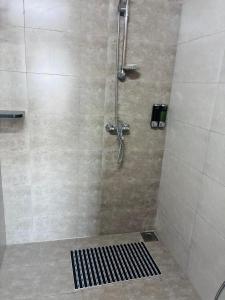 ein Bad mit einer Dusche mit einem schwarzen Gitter in der Unterkunft Majestic Manor Hotel Apartment Dakar Diamniadio in Rufisque