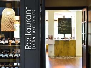 a store window with a display of wine bottles at ibis Beaune La Ferme Aux Vins in Beaune