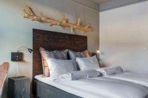 a bedroom with a bed with a antler above it at Trysil Hotel in Trysil