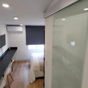 a room with a bed and a sliding glass door at Visitar La Campana in La Campana
