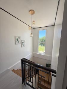 a staircase in a house with a window at Casa VLOM Staycation in Roxas City