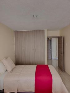 Postel nebo postele na pokoji v ubytování DEPARTAMENTO EN Riobamba