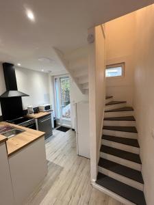a stairway leading to a kitchen with a staircase in a house at Maison Arques-la-Bataille à 5min de Dieppe in Arques-la-Bataille
