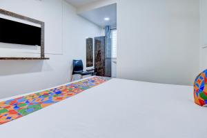 a bedroom with a large bed with a colorful patterned mattress at FabHotel World King in Pune