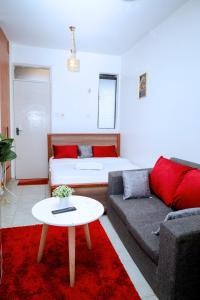 a living room with a couch and a bed at Studio in Roysambu with a study desk in Nairobi
