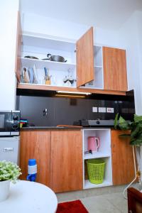 a kitchen with wooden cabinets and a counter top at Studio in Roysambu with a study desk in Nairobi