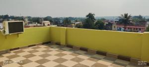 a green wall with a view of a city at HOTEL RS Palace in Ghātsīla