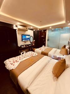 Ένα ή περισσότερα κρεβάτια σε δωμάτιο στο Majestik Hanoi Hotel