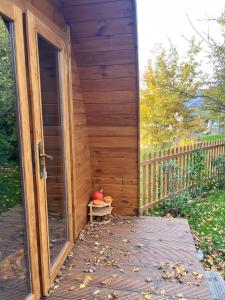 a wooden porch with a door and a bowl of fruit at La Parenthèse Enchantée in Rochefort