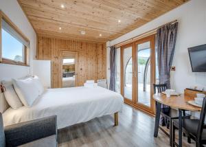 a bedroom with a bed and a desk and a television at South View Retreat in Carlton +29 photos