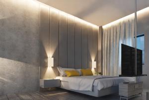 a bedroom with a large bed and a television at HYVE Siliguri in Siliguri