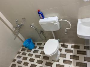 a bathroom with a toilet and a sink at Prime Place Guesthouse in Dibrugarh