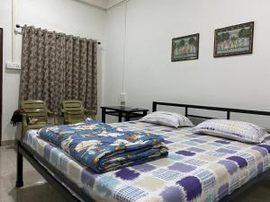 a bedroom with a bed with a quilt on it at Prime Place Guesthouse in Dibrugarh