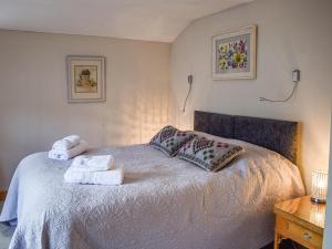 ein Schlafzimmer mit einem Bett mit Handtüchern darauf in der Unterkunft May Cottage in Rendham + 7 Fotos