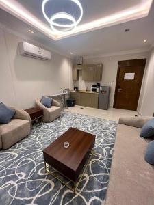 a living room with a couch and a coffee table at العييري ريزيدنس in Dammam