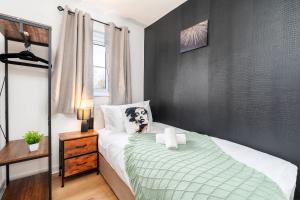 a bedroom with a dog pillow on a bed at Spacious 3 Bedroom Home with 6 Beds Private Garden and Driveway Parking in Manor