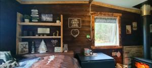 a bedroom with a bed and a window at Hjortebu i naturskjønne omgivelser in Åseral +11 photos