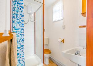 a bathroom with a toilet and a sink at Ravenna Holiday Park in Anderby +28 photos
