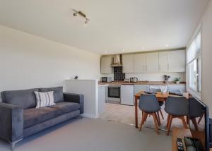 a living room with a couch and a table and chairs at Romansleigh Retreat in Romansleigh +33 photos