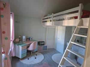 Schlafzimmer mit einem Schreibtisch und einem Etagenbett in der Unterkunft Villa pour 24h auto le mans in Teloché