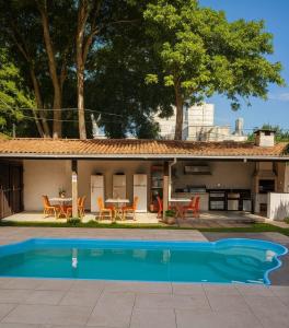 a house with a swimming pool in front of it at Hostel da Dani in Balneário Camboriú