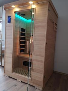 a shower with a glass door in a room at Appartement Panoramablick in Grattersdorf