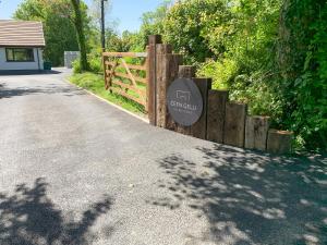 a sign on a fence next to a road at Cefn Gelli in Clynderwen +40 photos