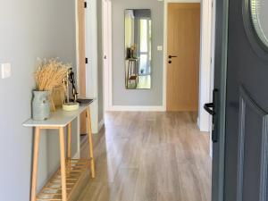a hallway with a table and a mirror and a door at Cefn Gelli in Clynderwen