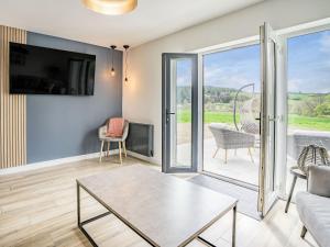 a living room with a couch and a table at Cefn Gelli in Clynderwen