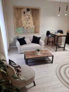 a living room with a couch and a table at Capitals Residence in Oświęcim