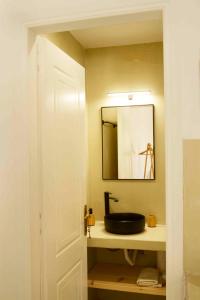 a bathroom with a black sink and a mirror at The endless blue hide out in Ios Chora