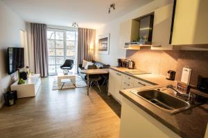 a kitchen with a sink and a counter top at Residenz am Balmer See - Kleine Auszeit - BS 21 mit Wellnessbereich in Balm