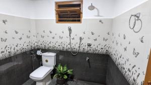 a bathroom with a toilet and a shower at MPR villa in Tangalle