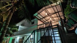 a house with a staircase leading to it at night at MPR villa in Tangalle