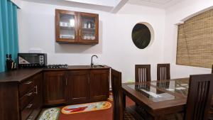 a kitchen with a counter top and a glass table at MPR villa in Tangalle +47 photos
