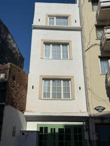 ein hohes weißes Gebäude mit zwei Fenstern darauf in der Unterkunft Nest Apart Ortaköy in Istanbul + 16 Fotos