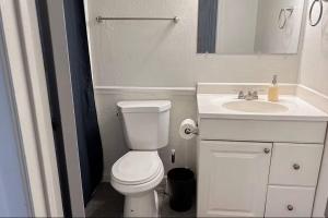 a bathroom with a white toilet and a sink at Desert Dwelling Resort Near Papago Park in Phoenix +15 photos