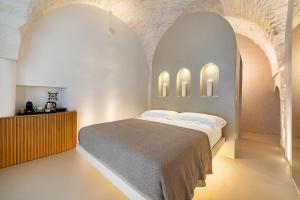 een slaapkamer met een bed en 2 gewelfde plafonds bij Casalis Luxury Room in Ostuni +22 foto's