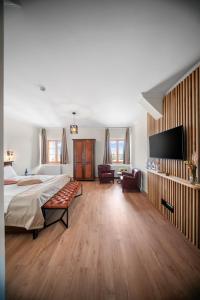 a large bedroom with a bed and a flat screen tv at OzonWellness in Harghita-Băi