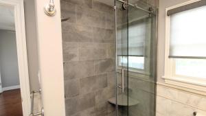 a shower with a glass door in a bathroom at Family Tides in Cape May +28 photos
