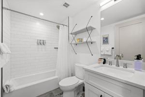a white bathroom with a toilet and a sink at 50 East 6th Ave A3 in Silverthorne +42 photos