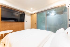a bedroom with a white bed and a large window at 스테이쉼 발산 in Seoul +3 photos