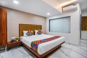 a bedroom with a large bed in a room at FabHotel New 7 Star in Mumbai