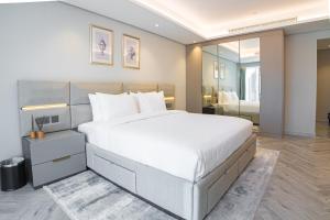 a bedroom with a large bed and a large mirror at Thirty Five Westbay Luxury Apartments in Doha +60 photos