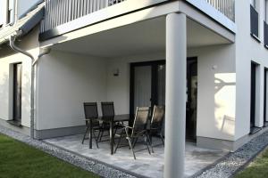 a patio with a table and chairs on it at WeberHof Appartements in Burg