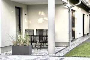a patio with chairs and a table on a building at WeberHof Appartements in Burg +16 photos